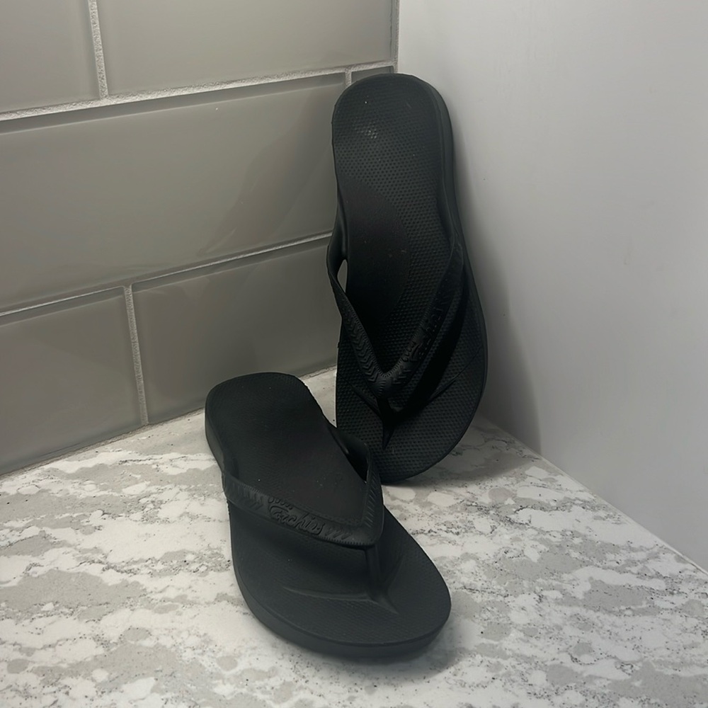 Archies black flip flops